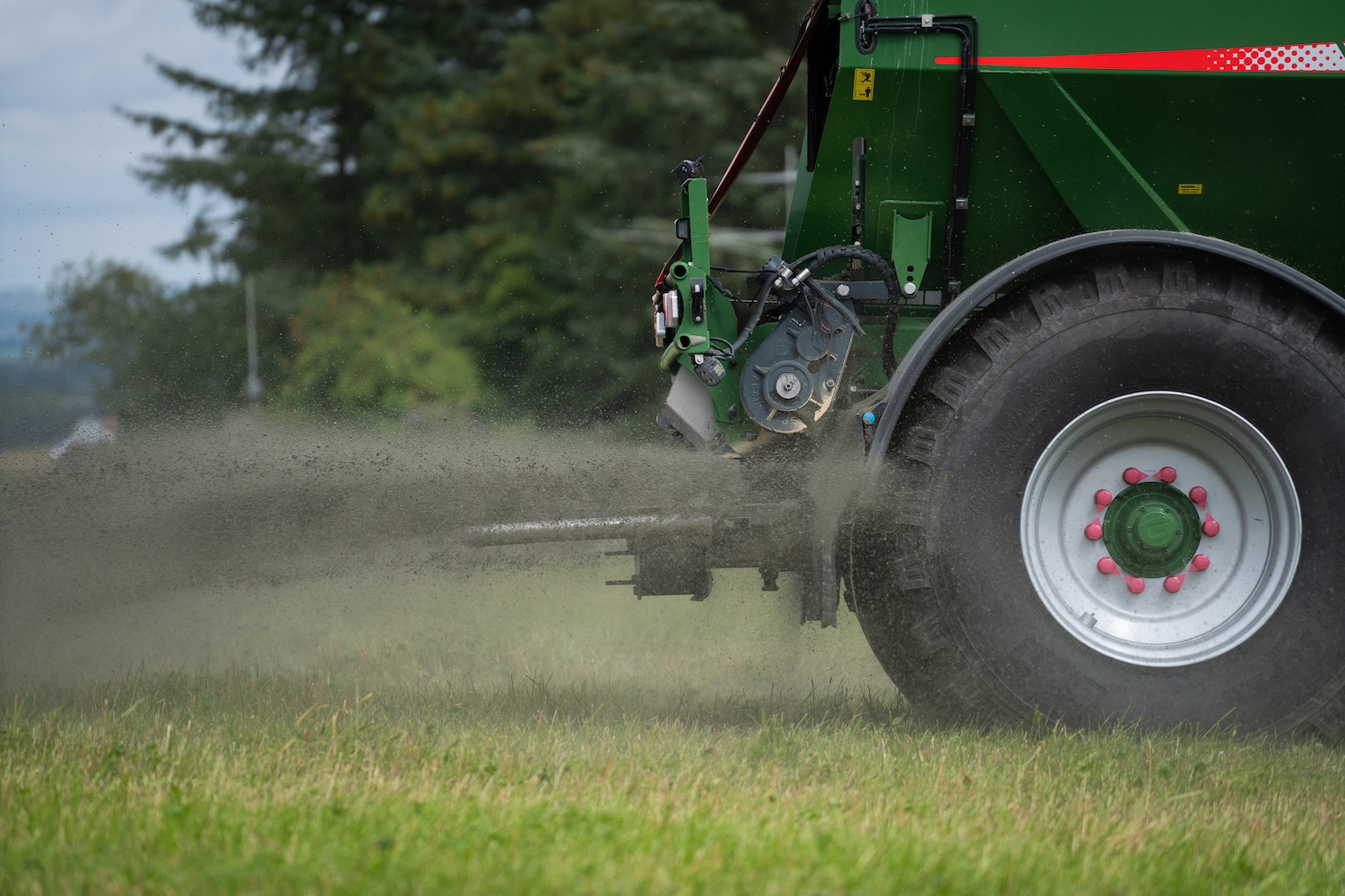 A close up of a tractor spreading crushed silicate rock on one of Undo's enhanced rock weathering test fields.